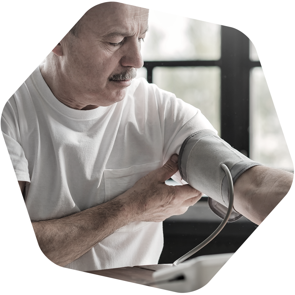 Older man with a blood pressure cuff on his arm.