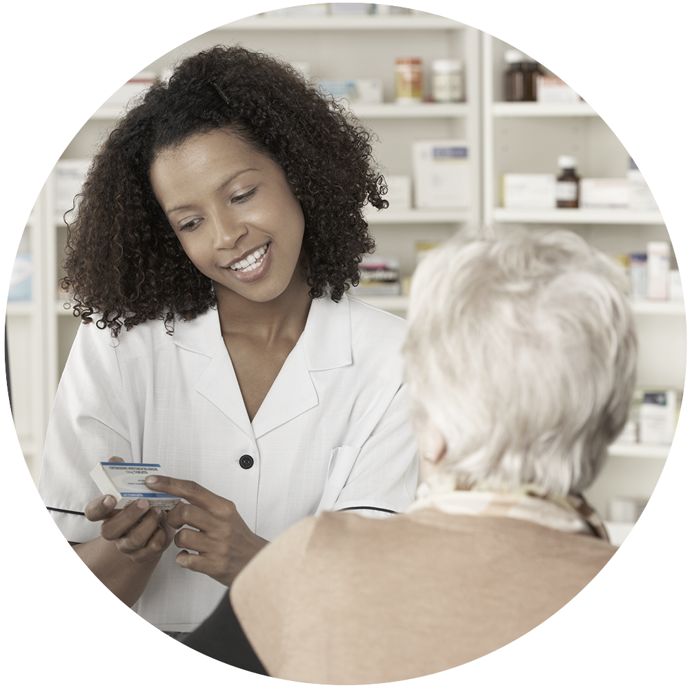 Woman pharmacist showing medication to elderly person.